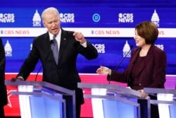 Democratic presidential candidates, former Vice President Joe Biden, left, and Sen. Amy Klobuchar, D-Minn., participate in a Democratic presidential primary debate at the Gaillard Center, Tuesday, Feb. 25, 2020, in Charleston, S.C.