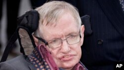 FILE - Professor Stephen Hawking arrives for the "Interstellar Live" show at the Royal Albert Hall in London, March 30, 2015. Hawking, whose brilliant mind ranged across time and space though his body was paralyzed by disease, March 14, 2018, at age 76. 