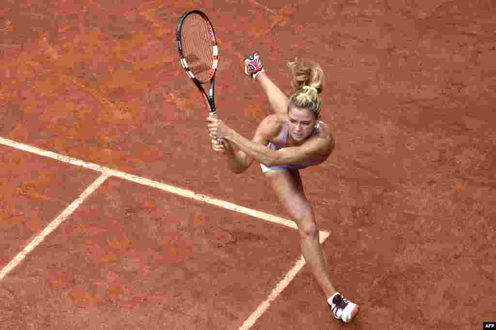 Italy's Camila Giorgi returns the ball to Russia's Svetlana Kuznetsova during the French tennis Open second round match at the Roland Garros stadium in Paris, France.