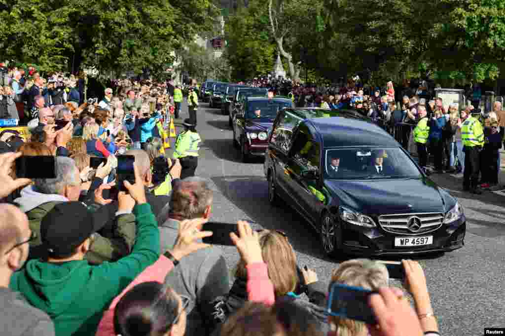The hearse carrying the coffin of Britain's Queen Elizabeth passes through the village of Ballater, near Balmoral, Scotland, Sept. 11, 2022.