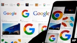 Various Google logos are seen in search results on two devices in New York, Sept. 11, 2023. (AP Photo/Richard Drew)