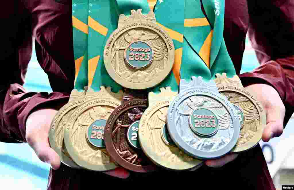 Canada's Margaret Mac Neil poses with the seven medals she won during the swimming events of the Pan American Games Santiago 2023, at the Aquatics Centre in Santiago, Chile, Oct. 25, 2023.