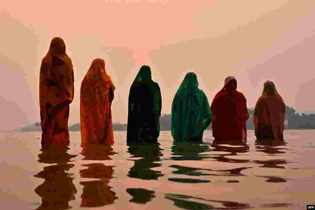 Hindu devotees offer prayers to the Sun god on the banks of river Brahmaputra during 'Chaiti Chhath Puja' festival in Guwahati, India.