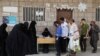 FILE - Beneficiaries of World Food Program assistance queue at a food distribution center amid exacerbating food shortages, in Sanaa, Yemen, July 18, 2023. 