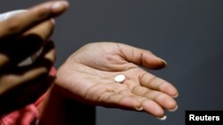 A patient prepares to take mifepristone at the Alamo Women's Clinic in Carbondale, Ill., April 20, 2023.