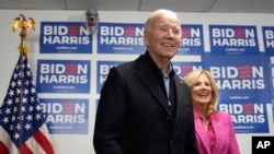U.S. President Joe Biden, left, waits to speak as first lady Jill Biden stands by his side at the Biden campaign headquarters in Wilmington, Delaware, Feb. 3, 2024. 