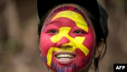 FILE - Ka Kathryn, a 25-year-old from a middle-class family, who is a guerrilla of the New People's Army, is seen in the Sierra Madre mountain range, east of Manila, on July 30, 2017. 