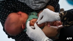 FILE - A baby receives the Bacillus Calmette-Guerin (BCG) vaccine for tuberculosis during a national immunization for children program at an integrated services post in Banda Aceh, Indonesia, on June 9, 2022.