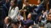 Chinese-born Australian journalist Cheng Lei, center, films a signing ceremony with Chinese Premier Li Qiang and Australian Prime Minister Anthony Albanese at Parliament House in Canberra, June 17, 2024. 