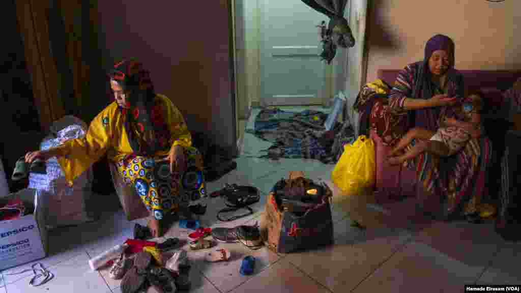 Salma, a mother of three, searches through used shoes for a pair to wear during the holiday. “My kids are young, but they understand what it means to be poor,” she says, “like when they see other kids with new outfits for Eid.”