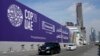 Cars pass by a billboard advertising COP28 at Sheikh Zayed Highway in Dubai, United Arab Emirates, Nov. 27, 2023.