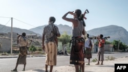 FILE - Members of the Afar militia stand in a checkpoint at the entrance of the town of Abala, 480 kilometers of Semera, Ethiopia, June 08, 2022.
