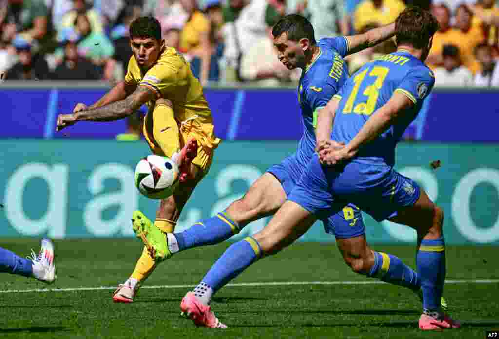 Romania's forward #17 Florinel Coman shoots on target during the UEFA Euro 2024 Group E football match between Romania and Ukraine at the Munich Football Arena in Munich, Germany.