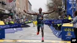 Evans Chebet of Kenya breaks the tape to win the 127th Boston Marathon, in Boston, April 17, 2023.