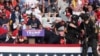 Republican presidential candidate and former U.S. President Donald Trump is assisted by U.S. Secret Service personnel after gunfire rang out during a campaign rally at the Butler Farm Show in Butler, Pennsylvania, July 13, 2024. 