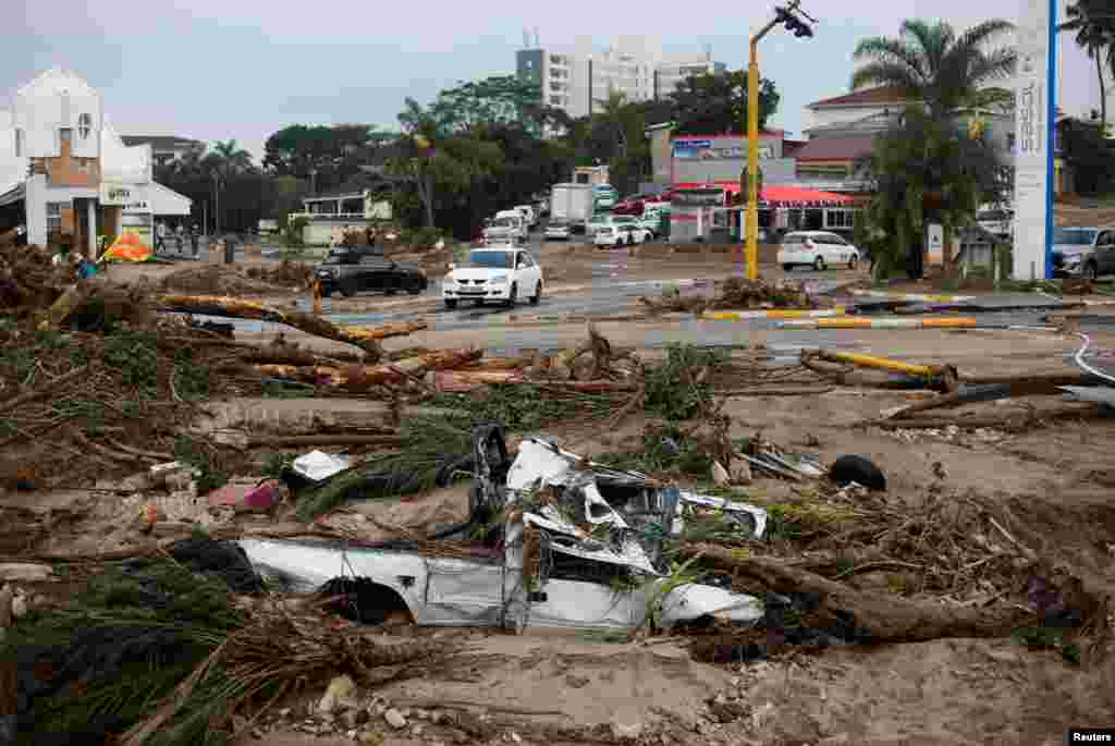 A car is buried in the sand after flooding caused extensive damage in Margate, South Africa, April 15, 2024.