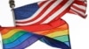 FILE - The Rainbow Flag, an international symbol of LGBT liberation and pride, flies beneath the American flag at the Stonewall National Monument on Oct. 11, 2017, in New York.