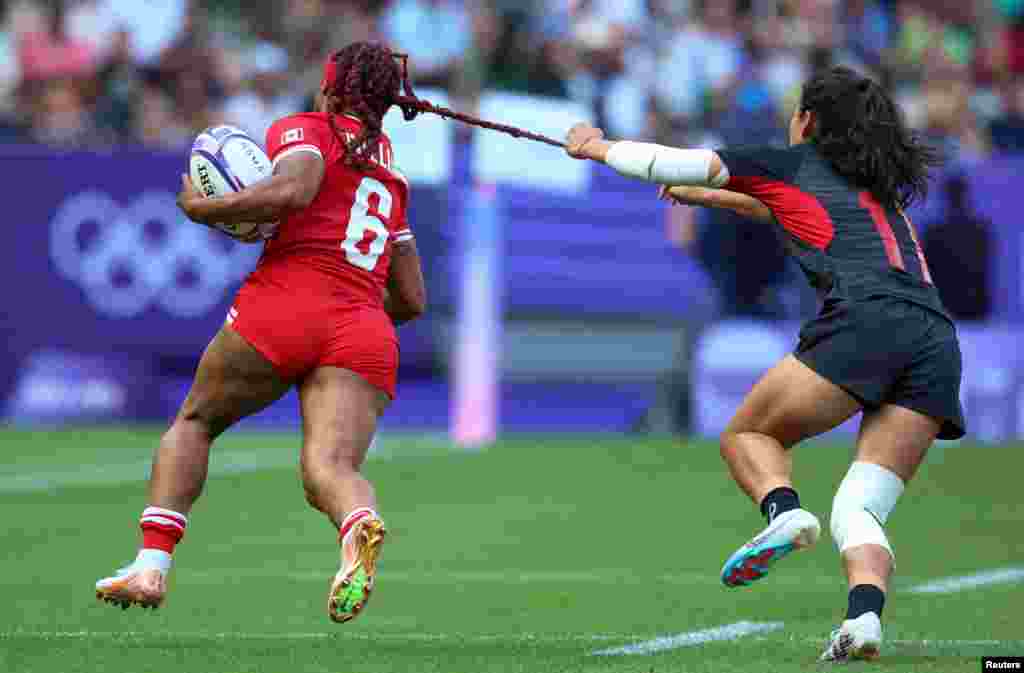Charity Williams of Canada is tackled by Xiaoqian Liu of China during the women's Rugby Sevens pool A match between Canada and China at the 2024 Summer Olympics in the Stade de France, France.