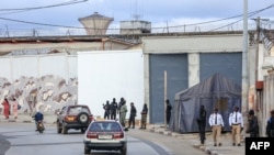 FILE - A general view of men in uniform outside the central prison in Libreville, Gabon, Sept. 11, 2023. Police in Gabon say a crime wave has hit the capital Libreville several days after the country’s transitional president pardoned and set free over 500 prisoners.
