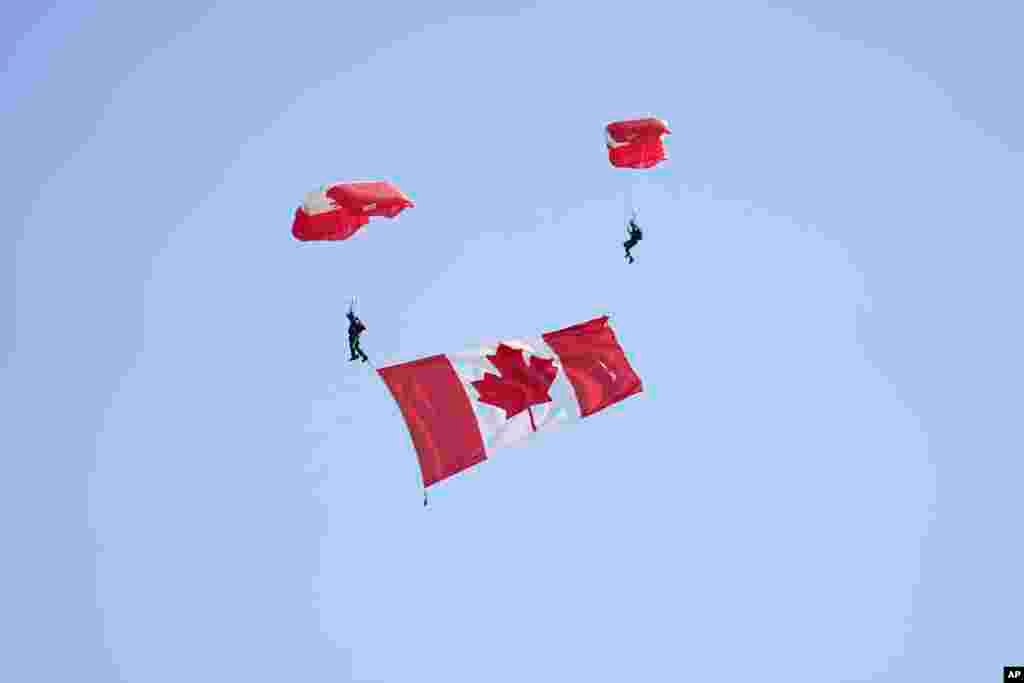 Parachuters drop over the event ahead of the Government of Canada ceremony to mark the 80th anniversary of D-Day, at Juno Beach in Courseulles-sur-Mer, Normandy, France, June 6, 2024. 
