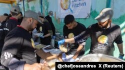 FILE - Members of "World Central Kitchen" prepare food for Palestinians, in the location given as Gaza, in this picture released on March 21, 2024 and obtained from social media. (Courtesy of @chefjoseandres via X/via REUTERS) 