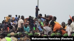 Thousands of Nigeriens gather in front of the French army headquarters in support of the putschist soldiers and to demand the French army to leave, in Niamey, Niger, Sept. 2, 2023.