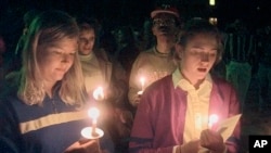 FILE — Students appear at a vigil against violence at Prexy's Pasture on the University of Wyoming campus in Laramie, Wyoming, Oct. 10, 1999, about a year after the death of Matthew Shepard, a gay student who was tied to a fence post, tortured, and left to die.