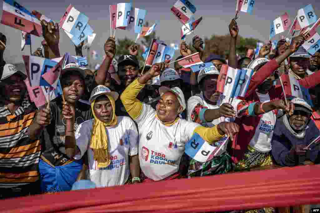 Rwandan Patriotic Front (RPF) supporters wave party flags and chant slogans in support of the Incumbent President of Rwanda and presidential candidate Paul Kagame during a campaign rally in Kigali, ahead of the 2024 Rwandan general election.