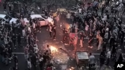 FILE - Iranians protest the death of Mahsa Amini, 22, after she was detained by the morality police, in Tehran, Sept. 20, 2022, in this photo taken by an individual not employed by The Associated Press and obtained by the AP outside Iran.