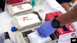 FILE - Syringes with vaccines are prepared at a resource center Oct. 28, 2022, in Lynwood, Calif. A new federal office launched on July 21, 2023, will prepare for and respond to potential pandemics.