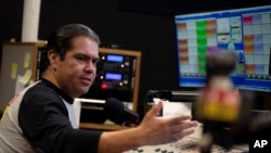 Host Tony "El Tigre" Arias speaks during a broadcast at the Phoenix studio of Radio Campesina, a Spanish-language network, March 21, 2024. The network is battling misinformation being aimed at voters ahead of the fall U.S. presidential election.