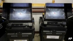 FILE - Dominion Voting ballot-counting machines sit at a warehouse in Estancia, New Mexico, Sept. 29, 2022. Several conservative networks, including Fox News, gave significant airtime to claims that Dominion machines were programmed to rig the vote count in favor of Joe Biden during the 2020 U.S. presidential election.