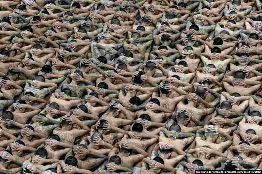 Gang members wait in their cells upon their arrival at the Terrorism Confinement Center, as part of a move announced by El Salvador's President Nayib Bukele on social media, in Tecoluca, June 11, 2024.