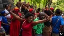 FILE - Believers dance during the St. George Vodou celebration in Port-au-Prince, Haiti, April 24, 2024.
