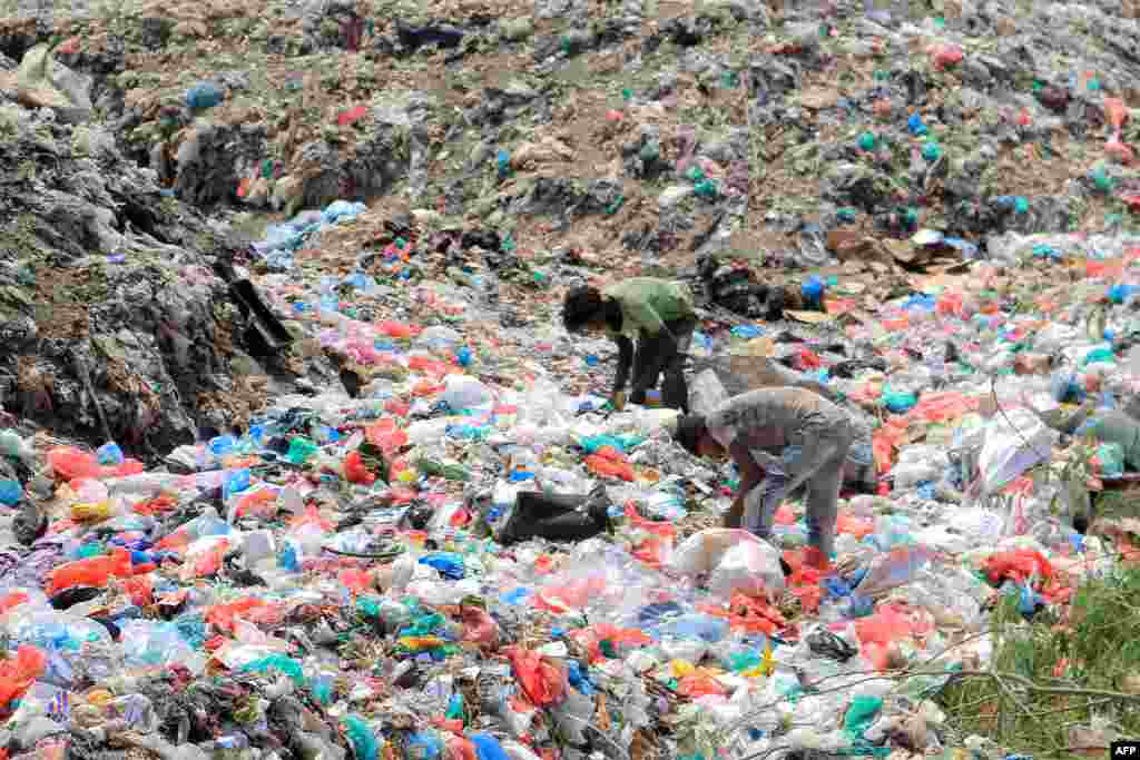 Youths collect recyclable items at a garbage dump in Yemen's Red Sea port city of Hodeida, Aug. 15, 2023.