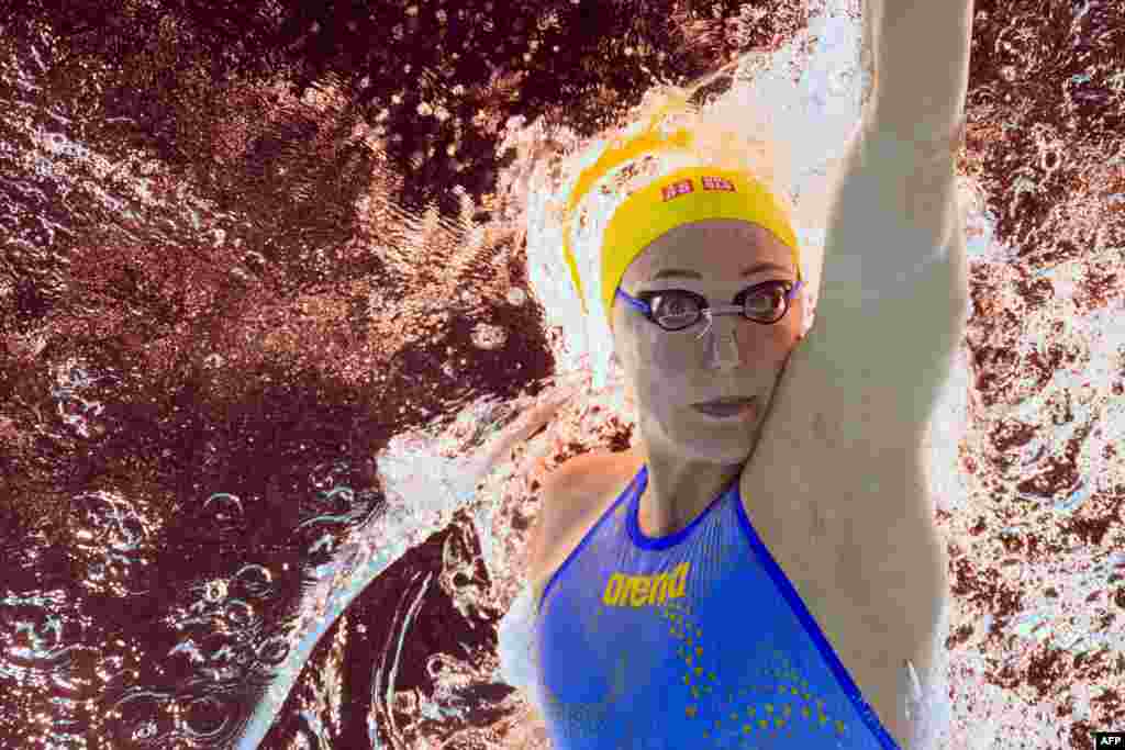 An underwater view shows Sweden's Sarah Sjoestroem competing in a heat of the women's 100m freestyle swimming event during the Paris 2024 Olympic Games at the Paris La Defense Arena in Nanterre, west of Paris.