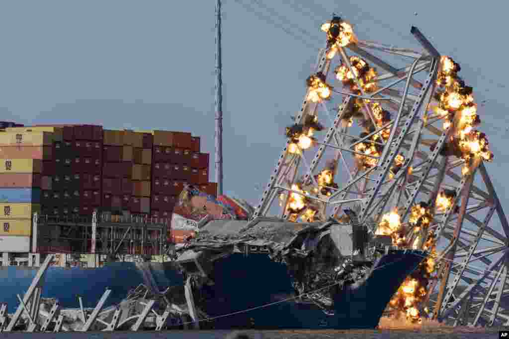 Explosive charges are detonated to bring down sections of the collapsed Francis Scott Key Bridge resting on the container ship Dali, May 13, 2024, in Baltimore, Maryland.