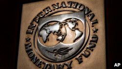 FILE - The logo of the International Monetary Fund is visible on its building in Washington, April 5, 2021. 