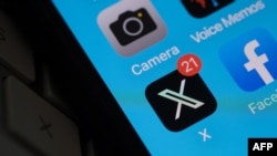 FILE - The X logo is seen on a smartphone screen in Los Angeles, Calif., on July 31, 2023.