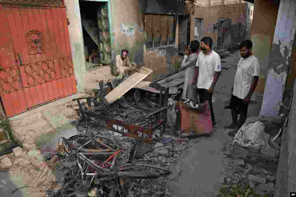 Christians look at homes vandalized by an angry Muslim mob in Pakistan on Aug. 17, 2023.