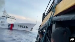 This image shows Filipino sailors look after a Chinese coast guard ship with bow number 5203 bumps their supply boat as they approach Second Thomas Shoal, in the South China Sea on Sunday Oct. 22, 2023. (Armed Forces of the Philippines via AP)