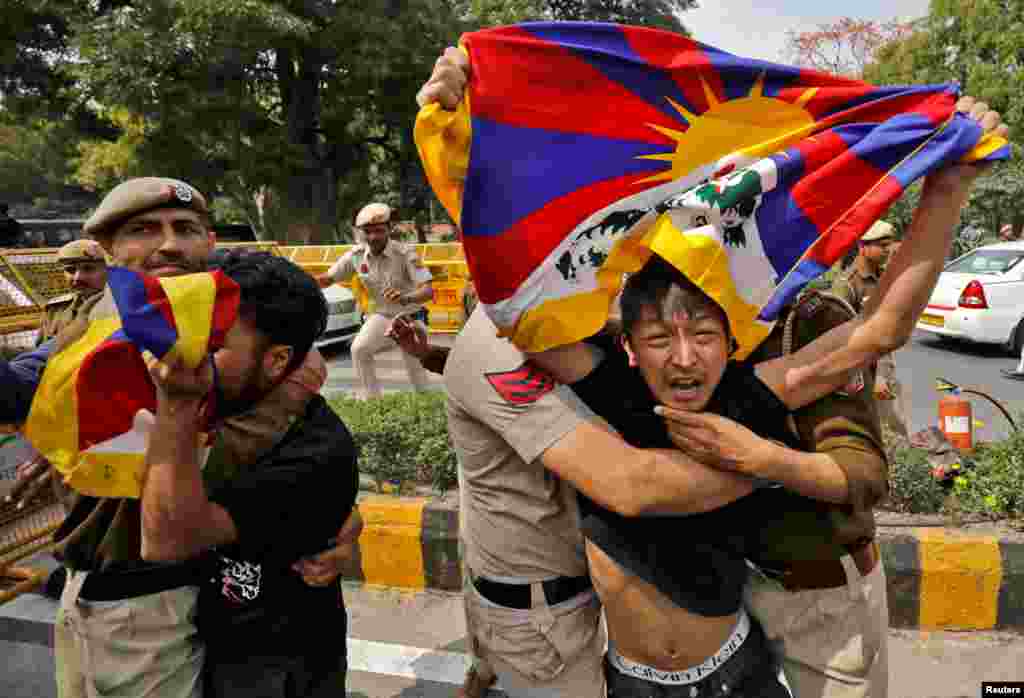 Tibetan exiles are detained by police during a protest against the visit of Chinese Foreign Minister Qin Gang, who is scheduled to participate in the G-20 foreign ministers' meeting, near the Chinese embassy in New Delhi, India.