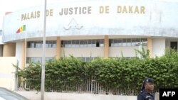 FILE - A Senegalese police officer is seen in front of a courthouse in Dakar on Sept. 21, 2022. 