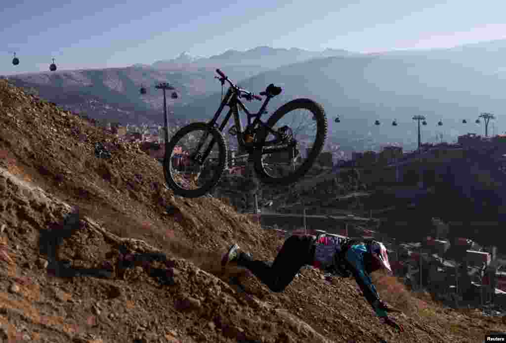 A cyclist falls during his practice ahead of the Challenge Downhill mountain biking race, in La Paz, Bolivia, June 30, 2024.