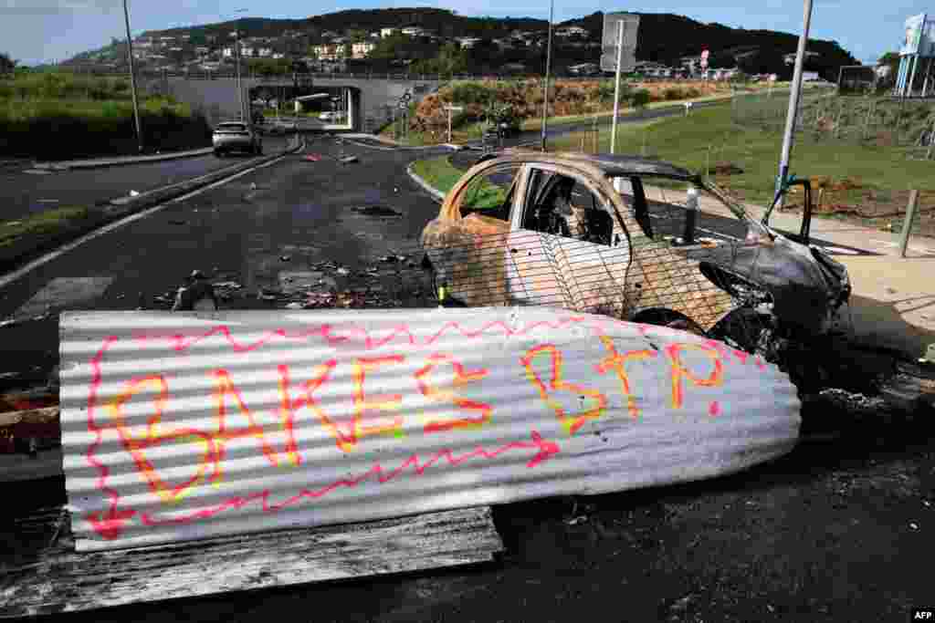 A slogan referring to French loyalist President of the South Province Sonia Backes is seen on a barricade since abandoned in Noumea, France's Pacific territory of New Caledonia. Separatists in riot-hit New Caledonia refused to abandon road blocks that have paralyzed much of the Pacific archipelago and halted commercial air traffic, defying a major security operation by French forces. 