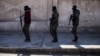 FILE - U.S. backed Syrian Democratic Forces soldiers search for Islamic State militants in Hassakeh, Syria, Jan. 28, 2022. 