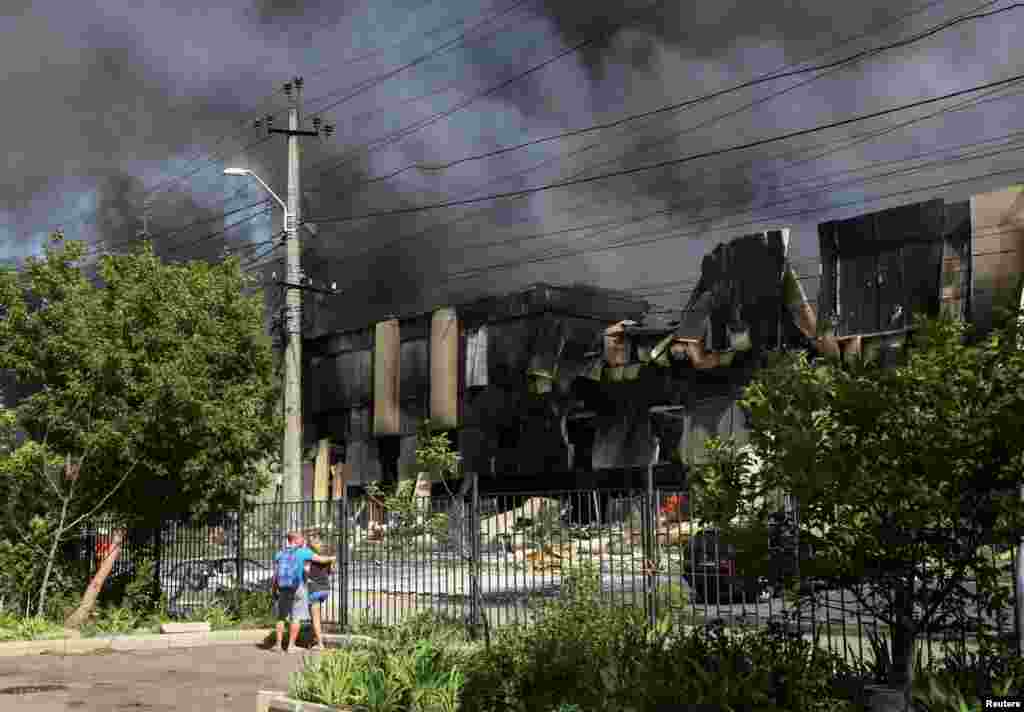 Local residents stand at a site of a Russian missile strike in Odessa, Ukraine.