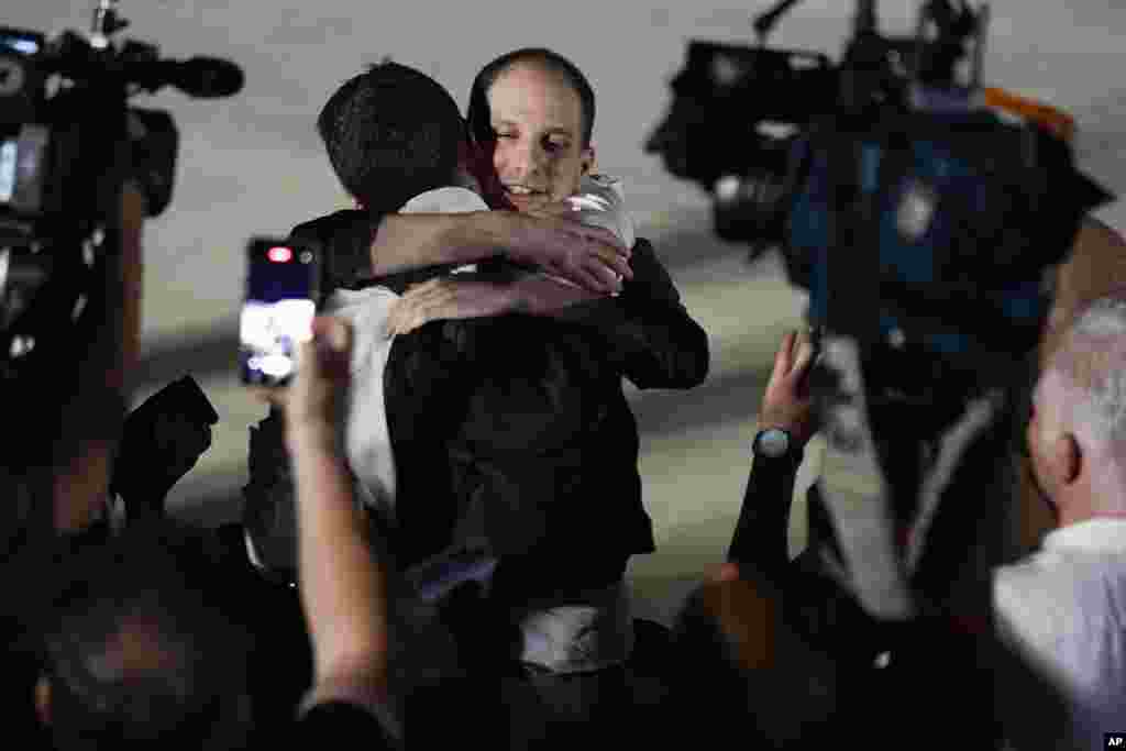 Reporter Evan Gershkovich receives an embrace from a colleague following his release as part of a 24-person prisoner swap between Russia and the United States on Aug. 1, 2024.