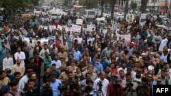 Traders shout slogans during a protest at a street in Karachi, Aug. 23, 2023, against the surge in petrol and electricity prices as Pakistan endures soaring inflation.