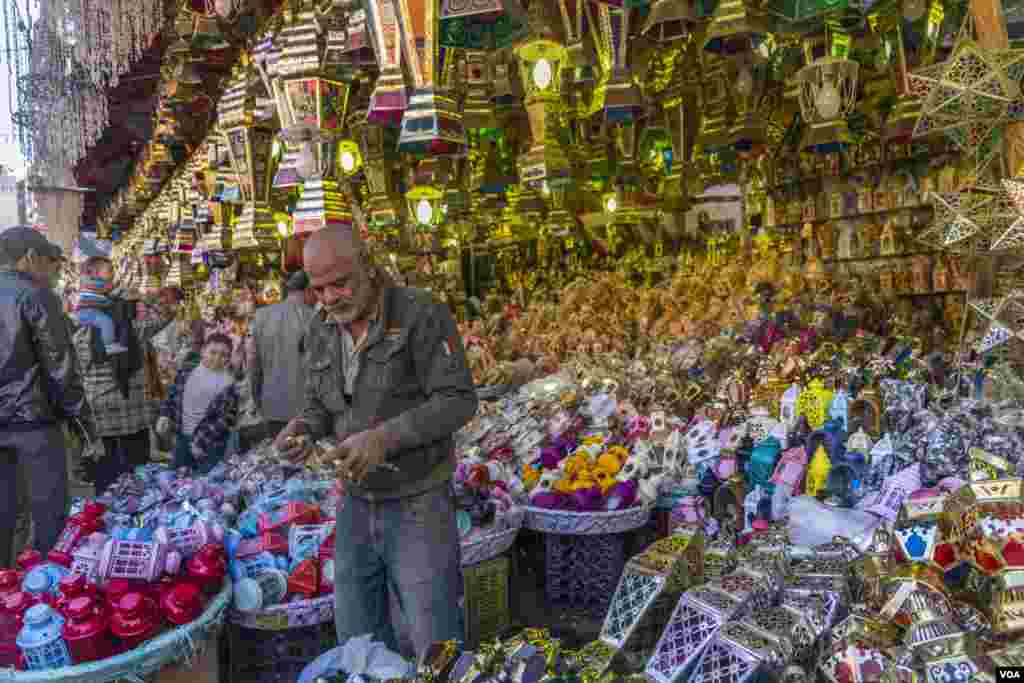 Abu-Osama Fawanies, who sells traditional Ramadan lanterns, says, ”The market is calm this season, with most shoppers coming in to check the prices or buy cheaper and small designs.” (Hamada Elrasam/VOA)